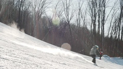 Skier rides down the prepared ski slope on a sunny winter day 動画素材 221818046