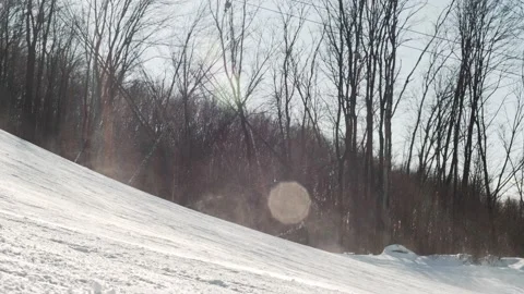 Skier rides down a ski slope at high speed on a winter sunny day at a ski resort Stock Footage 165137672