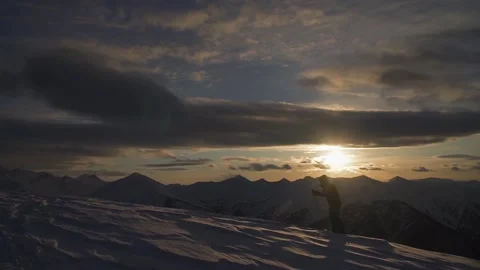 Skier on rides up at sunset Stock Footage 94408432
