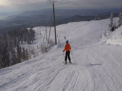 Skier is riding down fast upon ski track on the background of winter vall Stock Footage 71597681
