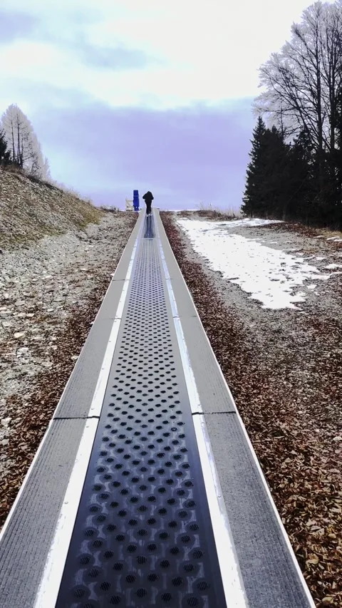 Skier Riding Magic Carpet Conveyor Belt at Ski Resort, Beginner Ski School Stock Footage 324813344