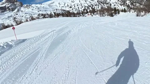 Skier shadow skiing downhill on a sunny winter day in the dolomites Stock Footage 340624264