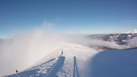 A skier skiing in the clouds in mountains , action camera footage Stock Footage 90010080