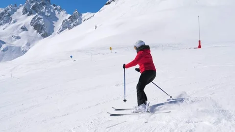 Skier skiing down beautiful snowy mountain slope Stock Footage 320122705