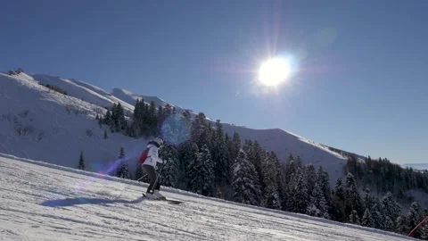 Skier Skiing Down On Ski Slopes On Ski On Sunny Winter Day Background Mountains Stock Footage 217374584
