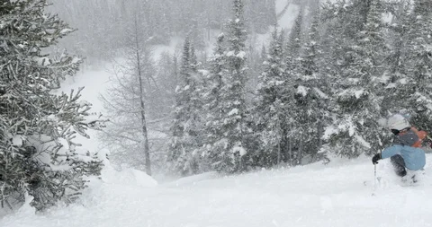 Skier skiing down the snow covered alps Stock Footage 86247885