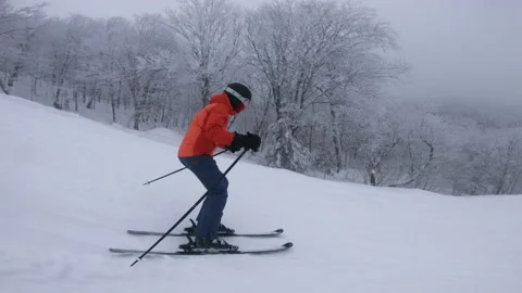 Skier Skiing Downhill on Ski Slope. Woman on ski going downhill having fun on Stock Footage
