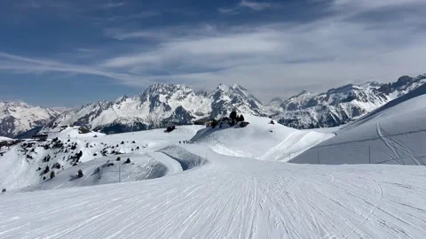 Skier  skiing on the slopes of Courchevel ski resort by winter Stock Footage 336928400