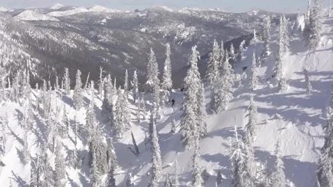 A Skier skis down a mountain in the sun Stock Footage 150135855