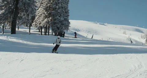 A skier slides down a large snowy slope Stock Footage 269854354