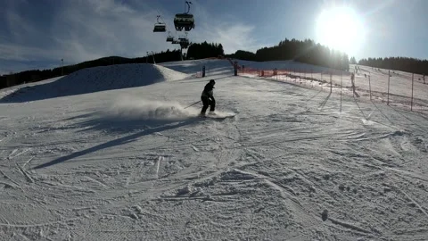 Skier spraying snow into camera in mountain ski resort. Stock Footage 143871556