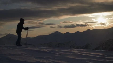Skier at the sunset down Stock Footage 94408316