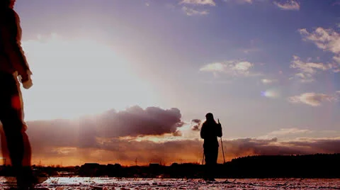 Skier at sunset, two friends Stock Footage 22475728