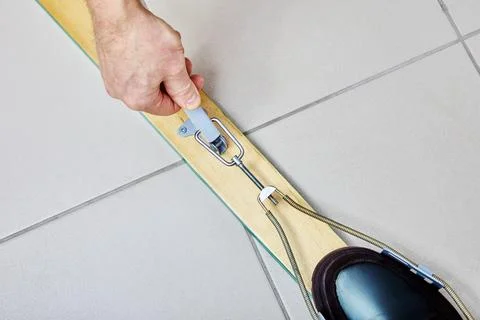 Skier tensions spring of cable ski bindings during installation and adjustm.. Stock Photos