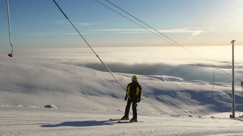 Skier using t bar ski drag lift Stock Footage 97736567
