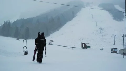 Skier walking in Slow Motion up mountain piste Stock Footage 221397968