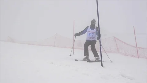 Skier who do slalom through gates installed on the slalom slope, bordered by  Stock Footage 78220523