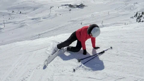 Skier woman getting up after falling on a snowy slope Stock Footage 323704157