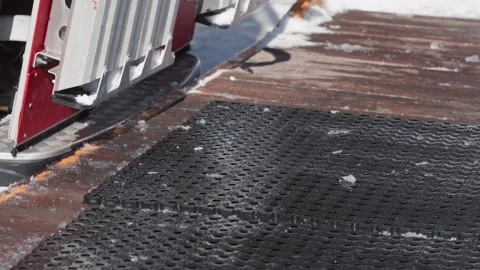 Skiers and snowboarders exit a cable car cabin, ready to hit the slopes with Stock Footage 304501936
