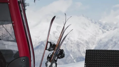 Skiers and snowboarders exit a cable car cabin, ready to hit the slopes with Stock Footage 304502149