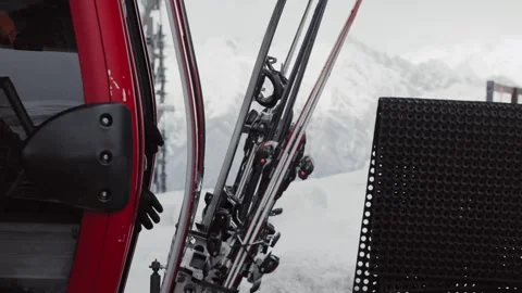Skiers and snowboarders exit a cable car cabin, ready to hit the slopes with Stock Footage 304504201
