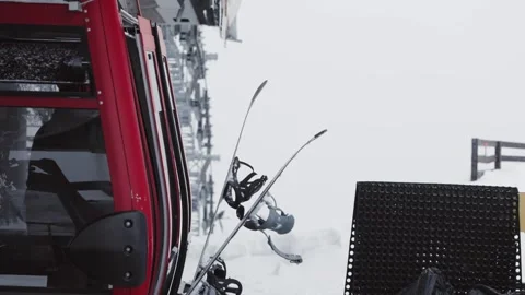 Skiers and snowboarders exit a cable car cabin, ready to hit the slopes with Stock Footage 304506567