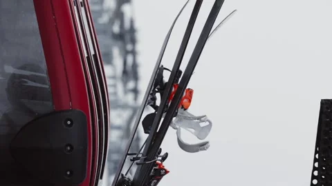 Skiers and snowboarders exit a cable car cabin, ready to hit the slopes with Stock Footage 304676683