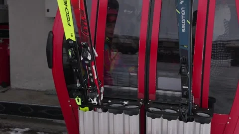 Skiers and snowboarders exit a cable car cabin, ready to hit the slopes with Stock Footage 304739746