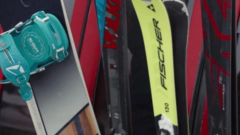 Skiers and snowboarders exit a cable car cabin, ready to hit the slopes with Stock Footage 304739776