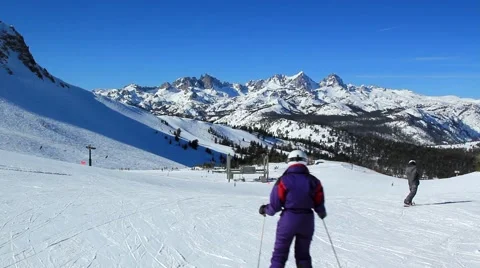 SKIERS AWAY FROM CAMERA Stock Footage 1011756