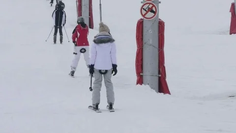 Skiers climb next to the ski, using a steel telesky Stock Footage 71452526