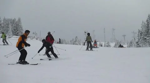 Skiers coming down slopes Stock Footage 58653824