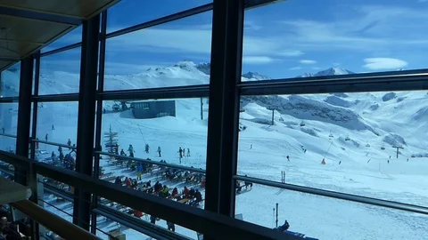 SKIERS IN FRONT OF WINDOW ISCHGL Stock Footage 121480280