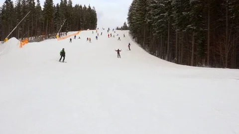Skiers go down the slope in a ski resort Stock Footage 88921546