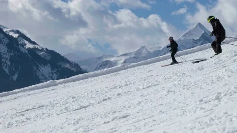 Skiers going down a mountain in slow motion Stock Footage 231550750