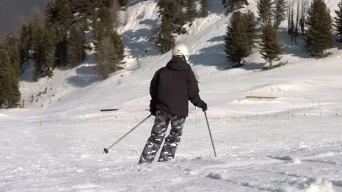 Skiers going down slope Stock Footage 183362859