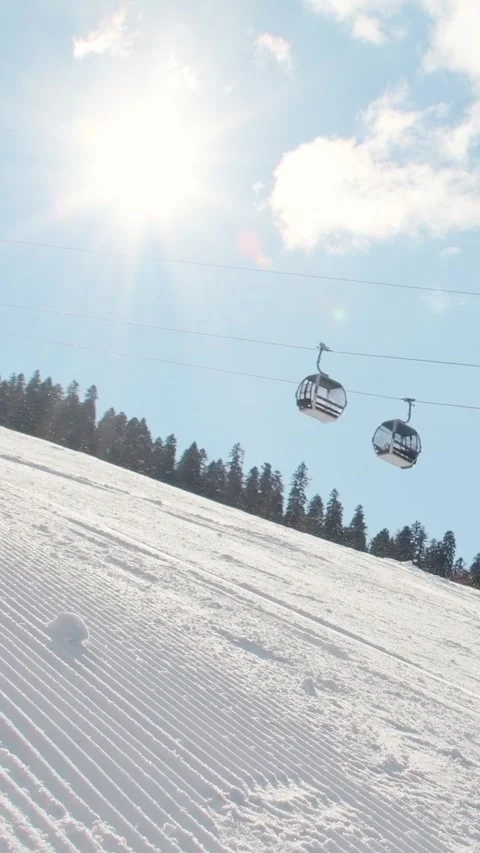 Skiers groups skiing sliding down groomed snowy mountain slope with forest .. Stock-Footage 324950355