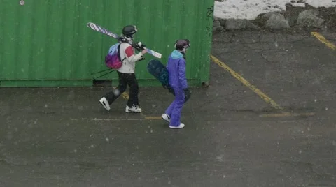 Skiers heading for the slopes while outside snowing profusely Stock Footage 68944788