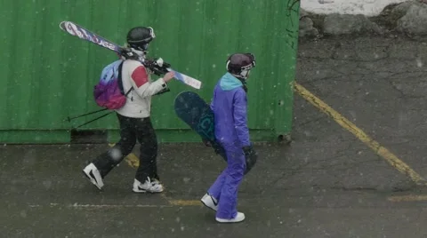 Skiers heading for the slopes while outside snowing profusely Video stock 68944860