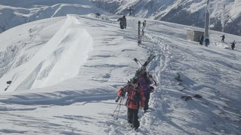 Skiers hike up the summit Stock Footage 46147944