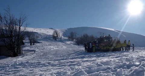 Skiers Loading to the Back of a Snowcat on a Snow Covered Mountain at a Winter Stock Footage 72412190