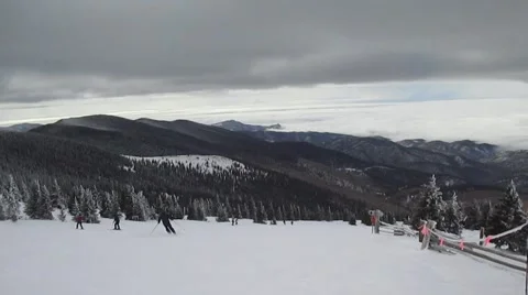 Skiers with mountain range in background Stock Footage 58653692