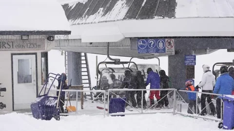 Skiers Queue Amid Heavy Snowfall at Mountain's Peak, BC, Canada, Jan 2023 Video stock 253121762
