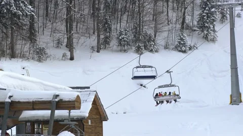 Skiers ride on the ski lift with big baskets Stock Footage