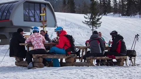 Skiers sitting at the table Stock Footage 76038155