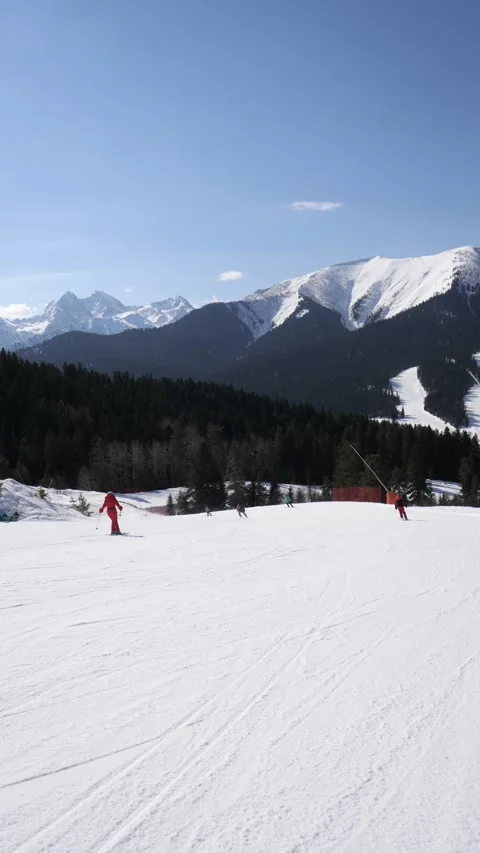 Skiers skiing down mountain slope in winter ski resort Stock Footage 342811516