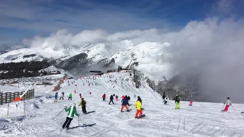 Skiers Skiing Down A Slope Stock Footage 73382312