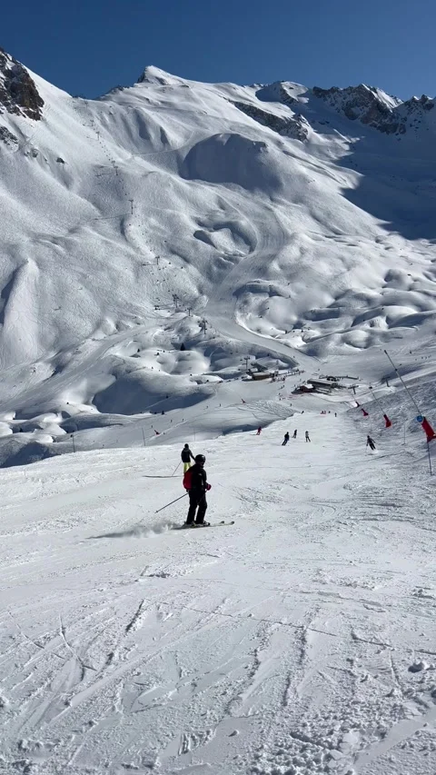 Skiers Skiing on the slopes of Courchevel Stock Footage 337054342