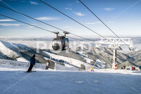 Skiers on the slope. Cableway Funitel in Low Tatras mountains, Slovakia Stock Photos