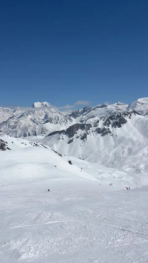Skiers on the slopes of Courchevel ski resort by winter Stock Footage 334442353